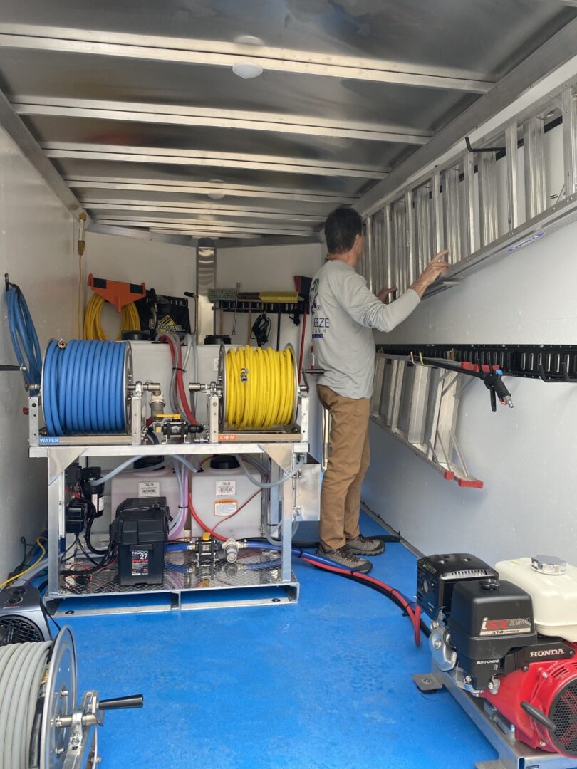 A man working on the back of a truck.